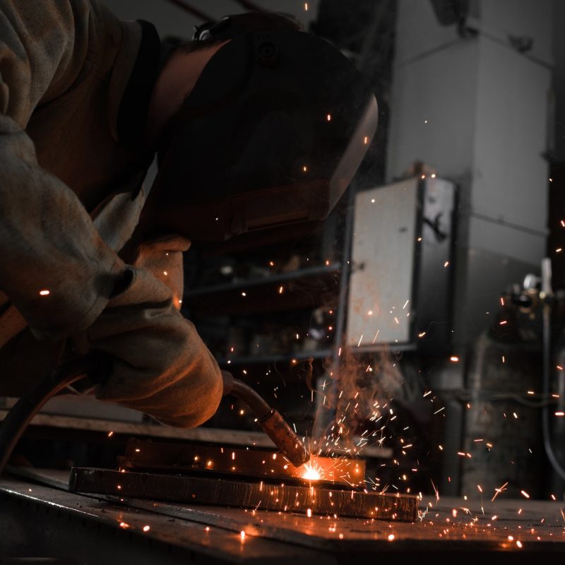 Manufacture Worker Welding Metal With Sparks at Factory